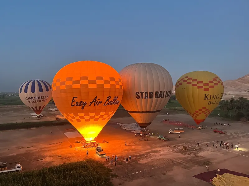 Hot air balloons being inflated at dawn in Luxor