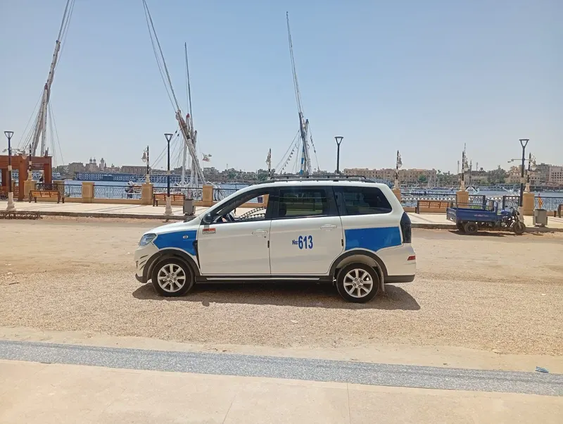 White and blue DFSK Glory minivan by the Nile