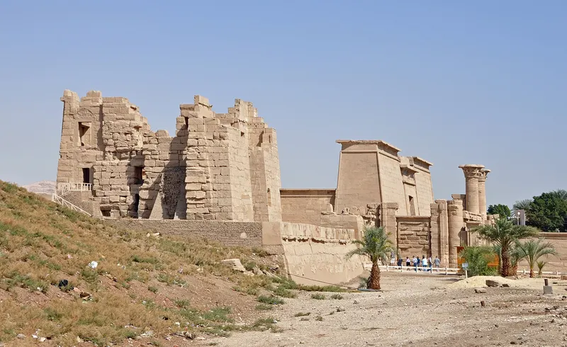 The temple complex of Medinet Habu among palm trees