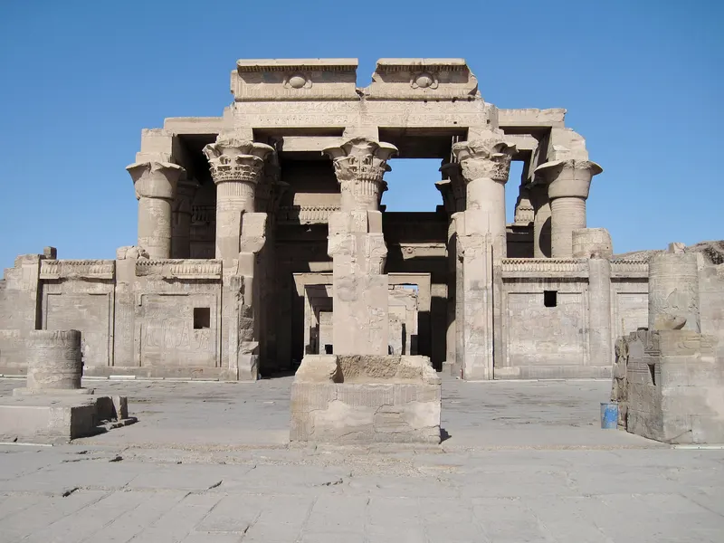 Columns of Kom Ombo Temple against a blue sky
