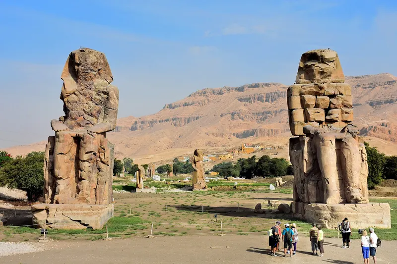 The two Colossi of Memnon under a blue sky
