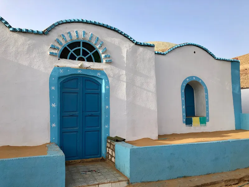 A white and blue painted house in a Nubian village