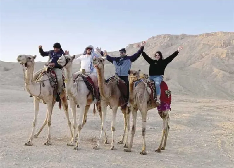 Guests on camels in the desert