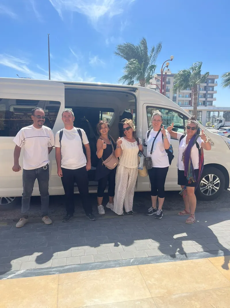 A group of guests in front of the van