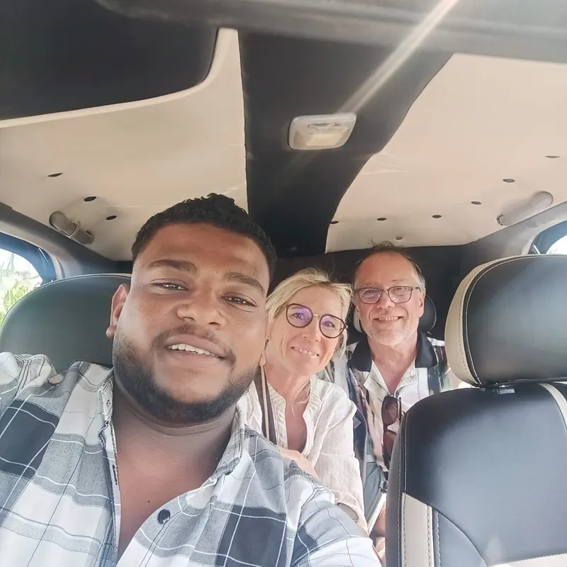 Guests smiling inside the car